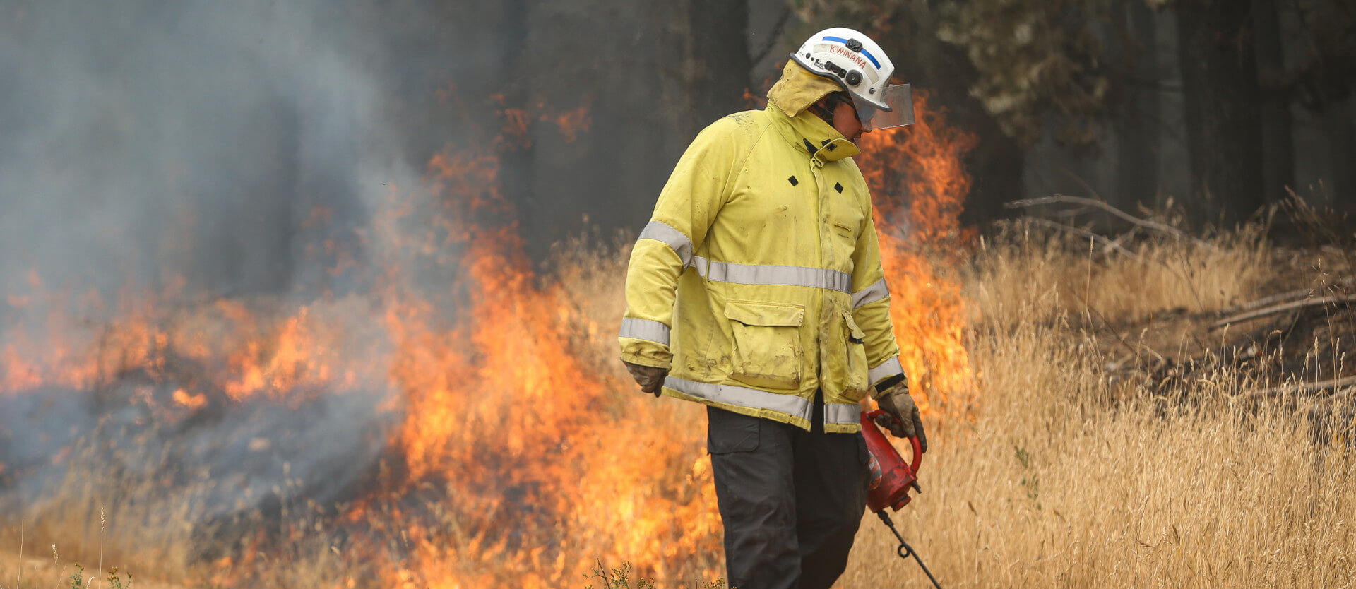 Firefighter creating firebreak with torch